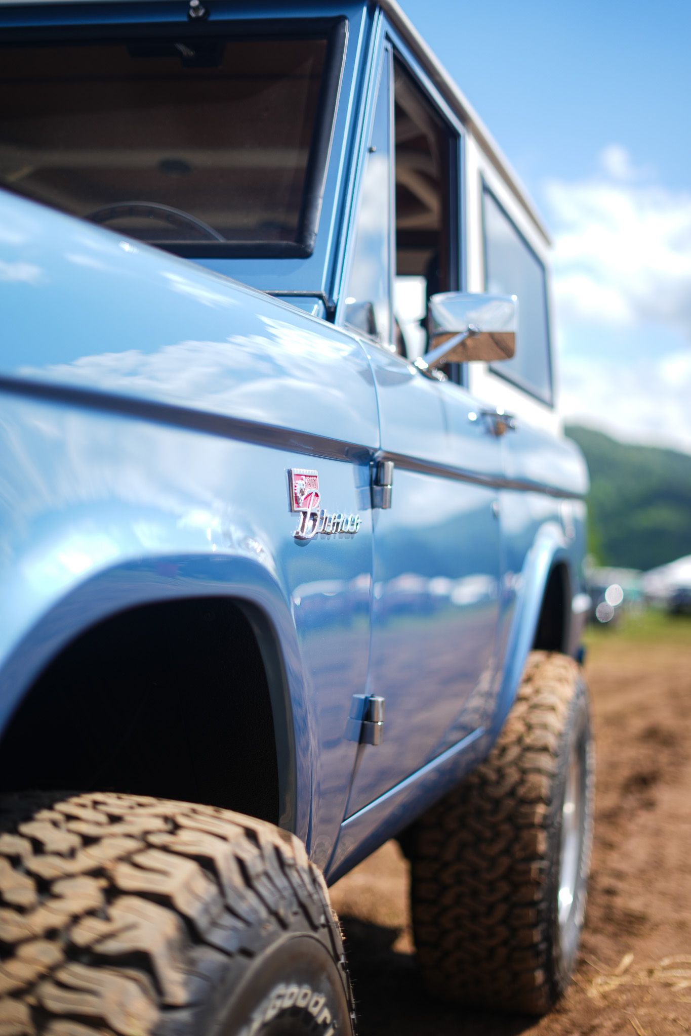 Light blue classic truck body panel with off-road tires shown in profile.