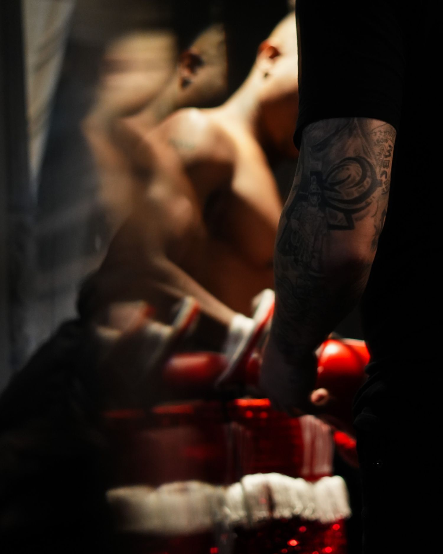 Close-up artistic shot of boxing gloves and equipment in dramatic lighting.
