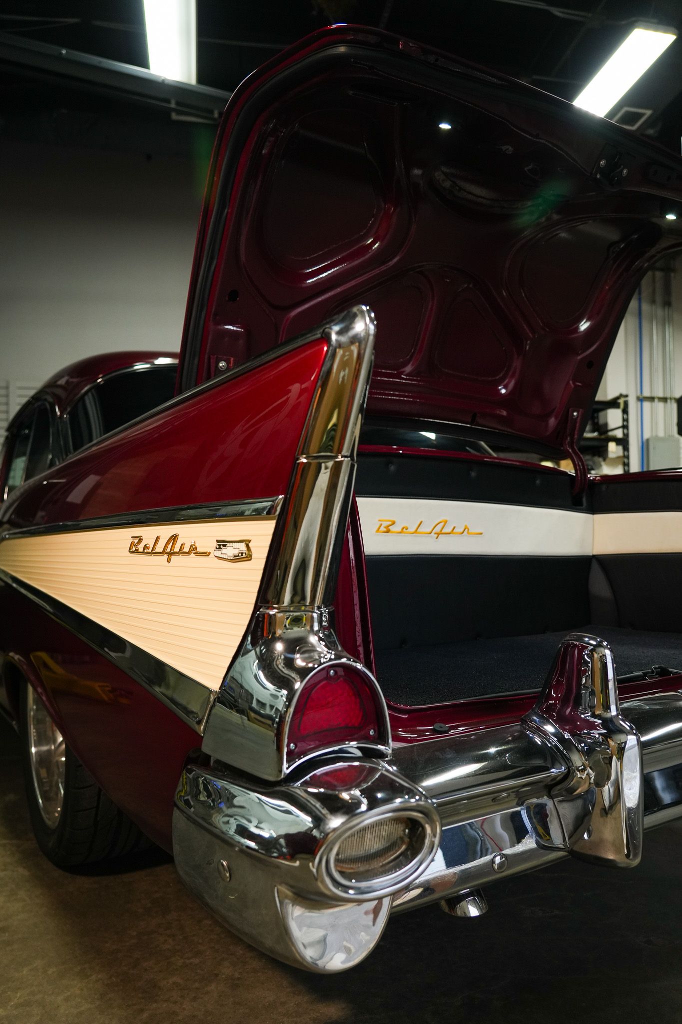 Burgundy vintage car with chrome trim and distinctive tail fin design.
