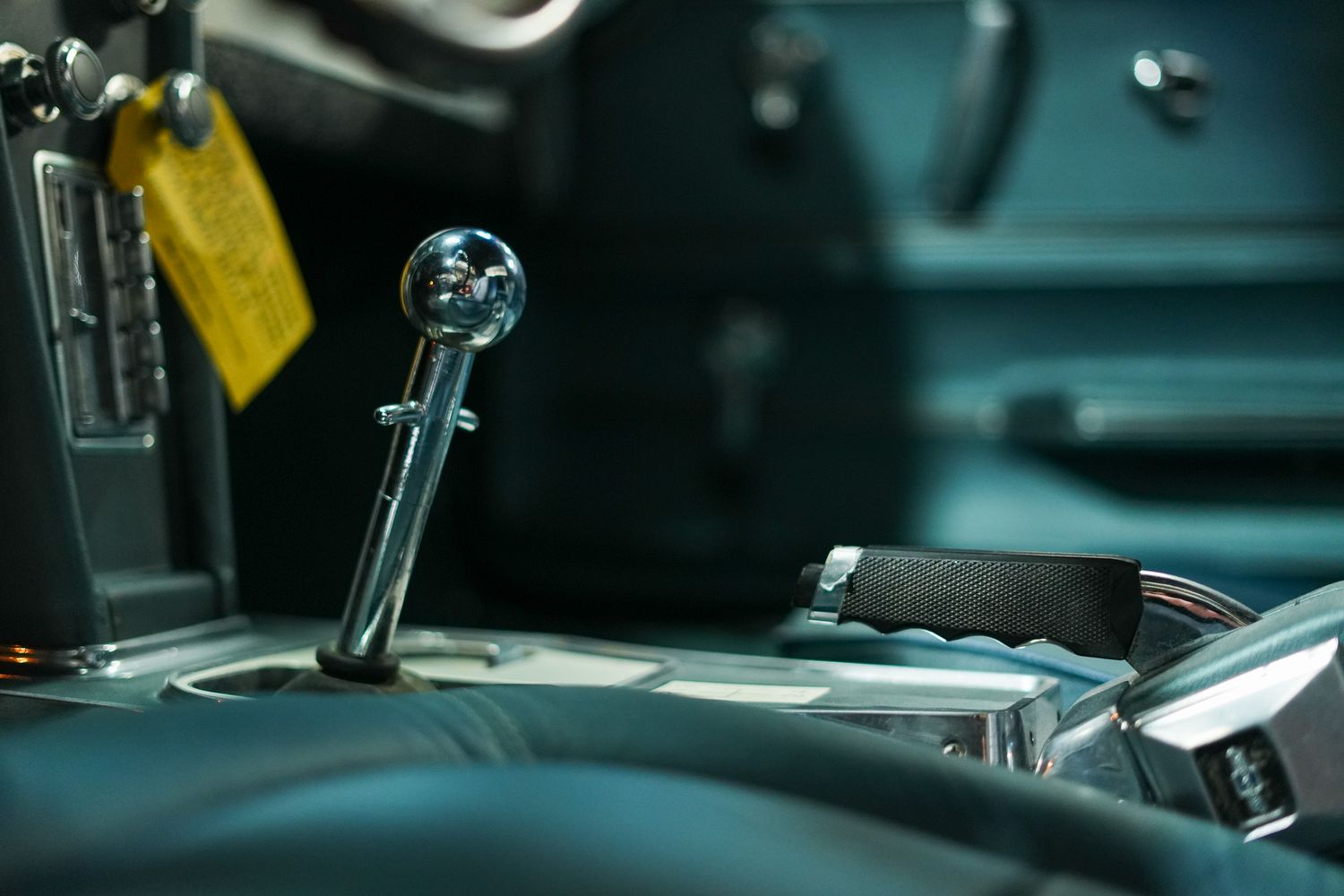 Classic car interior details with chrome trim and leather upholstery.