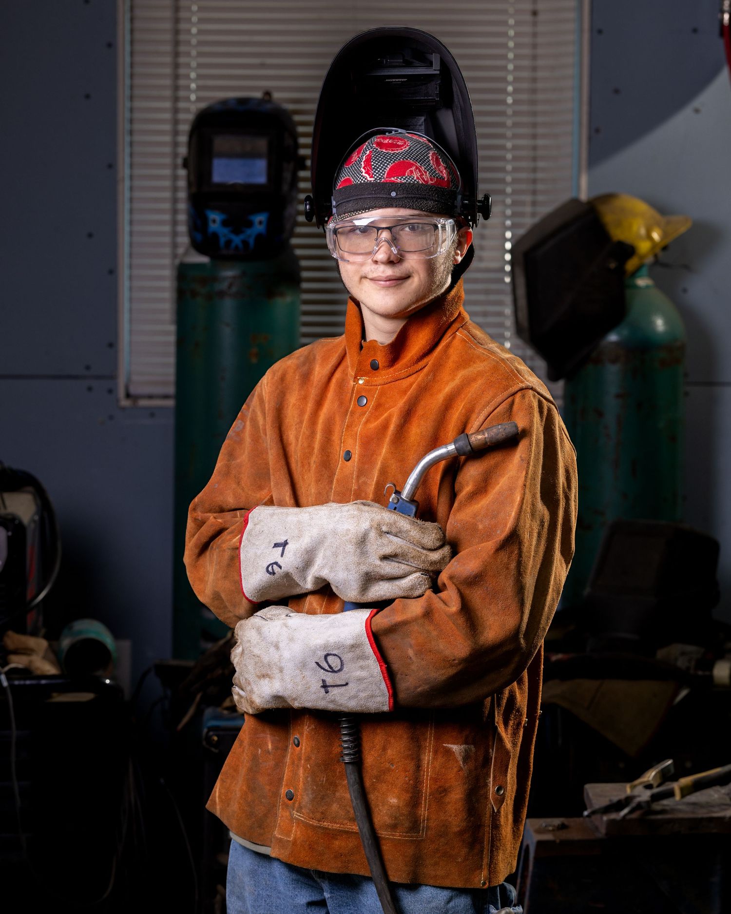 Trent's senior photo. Indoors with welding wand.