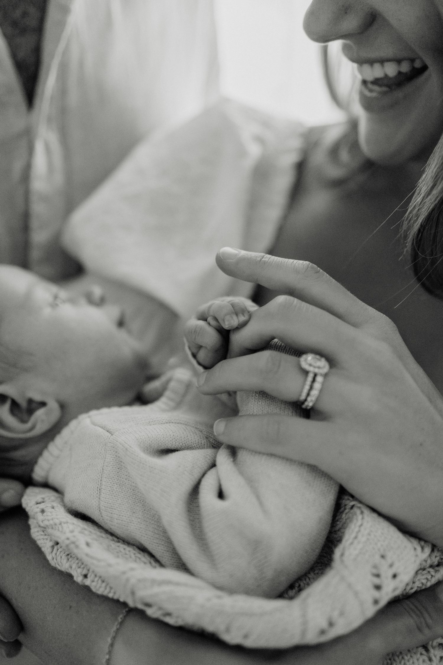 Geelong newborn photography - black and white close-up of a newborn baby holding mum's finger.