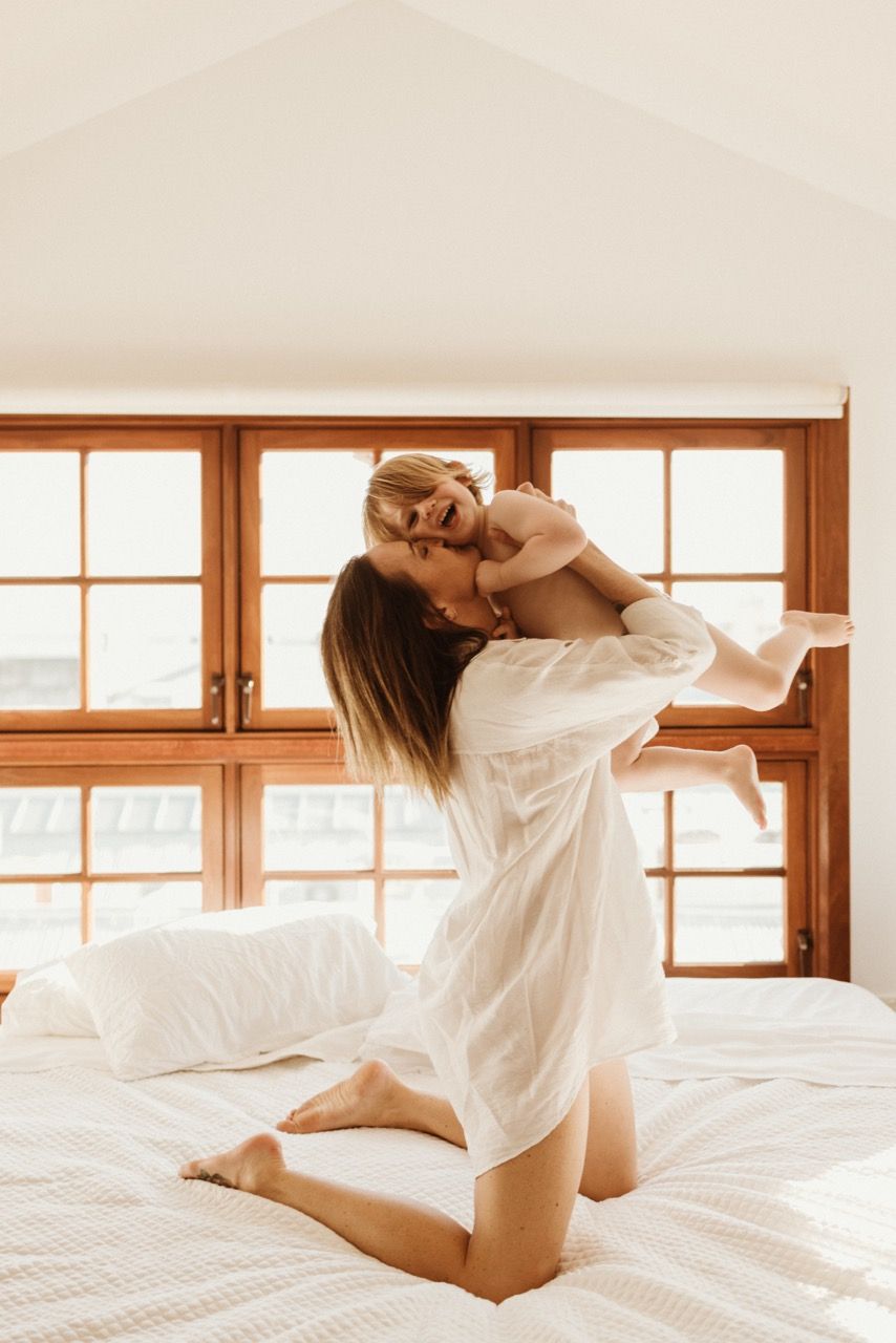 Joyful morning scene with white linens against rustic wooden windows.