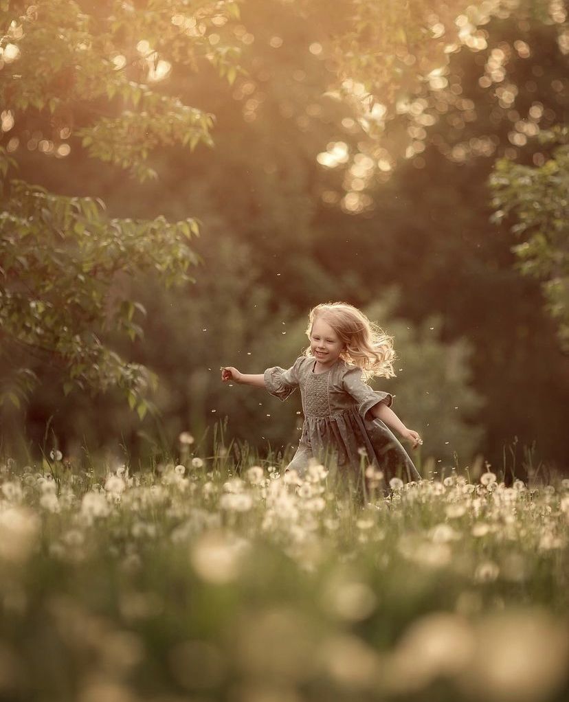Little girl running in a flower field