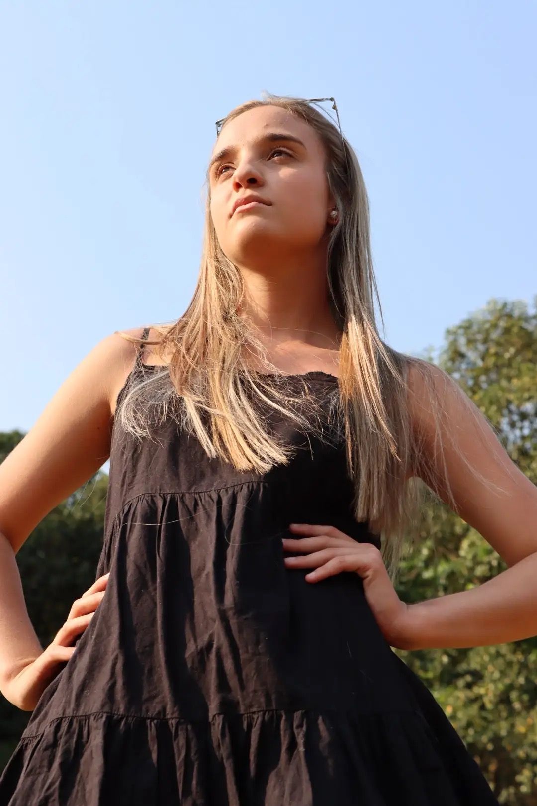 Confident girl in black dress looking in the distance