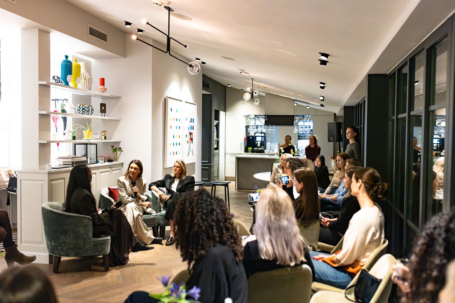 People gather in a modern Elle space for bookclub