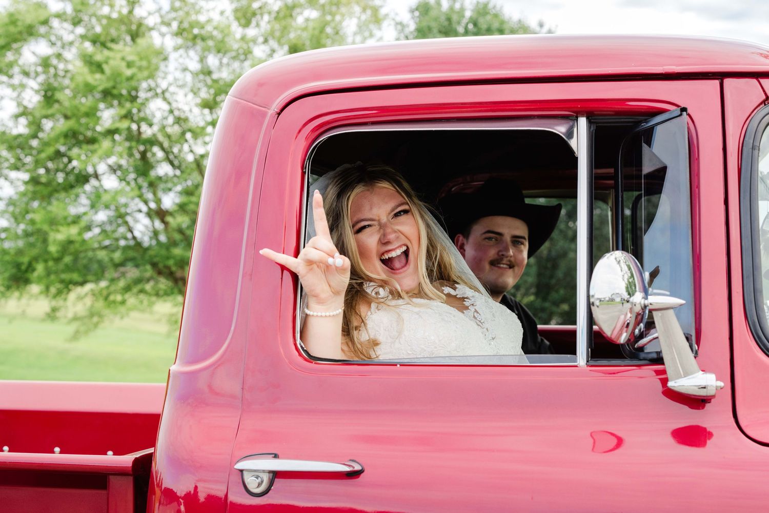 Professional wedding photography / photo / photography on a golf course, bride and groom in red truck, sendoff, send off, couples
