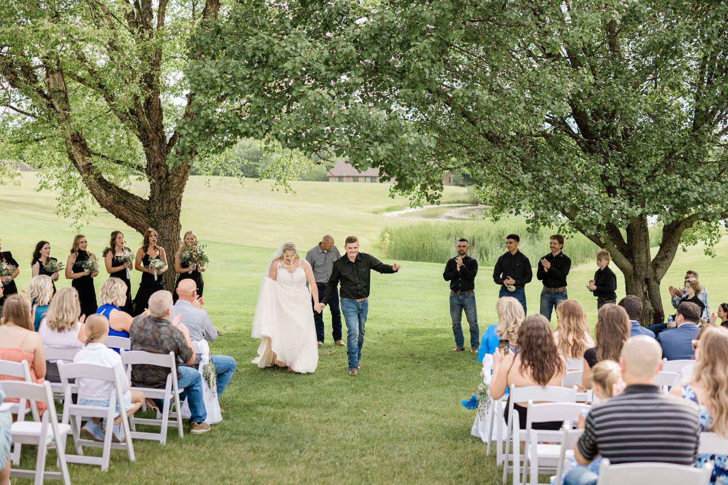 Professional wedding photography / photo / photography on a golf course, just married, bride and groom, coming down the aisle, husband wife