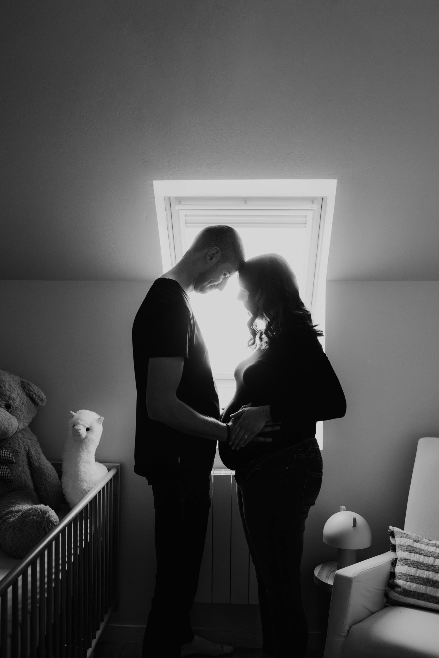 couple de futurs parents l'un en face de l'autre en lumière contre jour