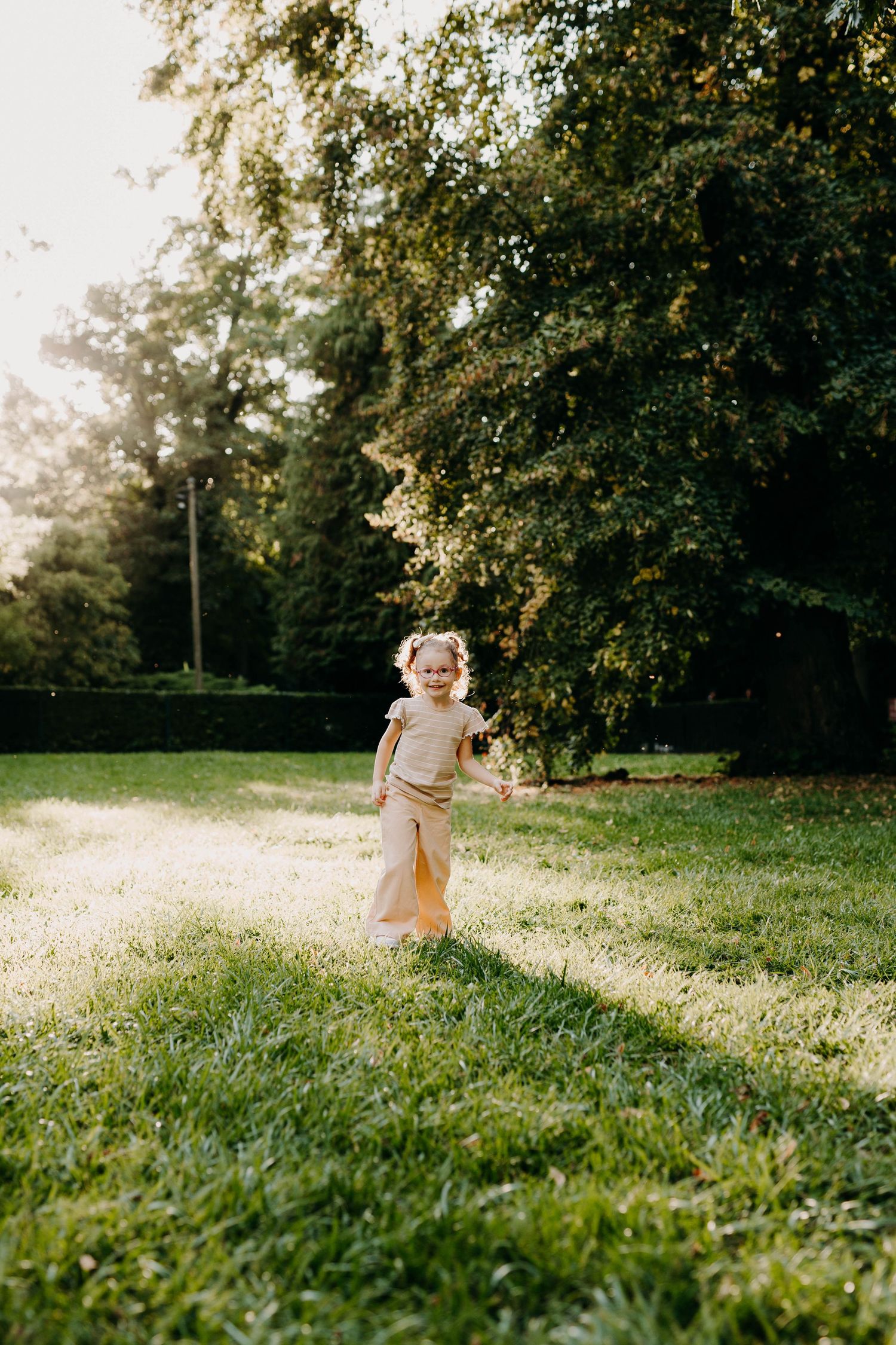 petite fille dans l'herbe qui pose