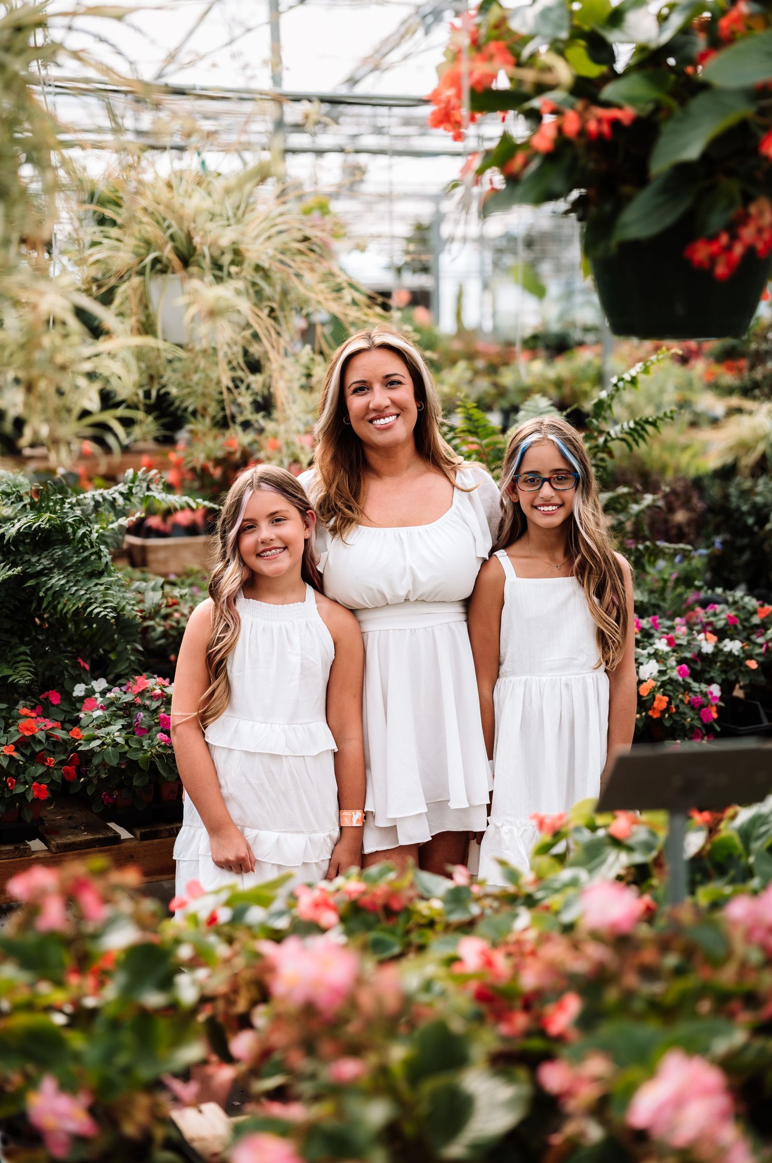 Family photoshoot in a flower nursery with photographer located throughout the Kansas City Metro area. Based in Blue Springs, Missouri.