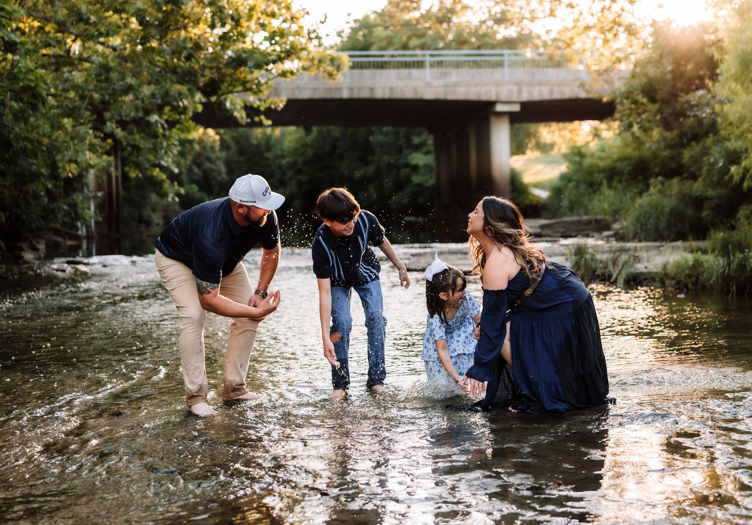 Family photoshoot in a creek with photographer located throughout the Kansas City Metro area. Based in Blue Springs, Missouri.