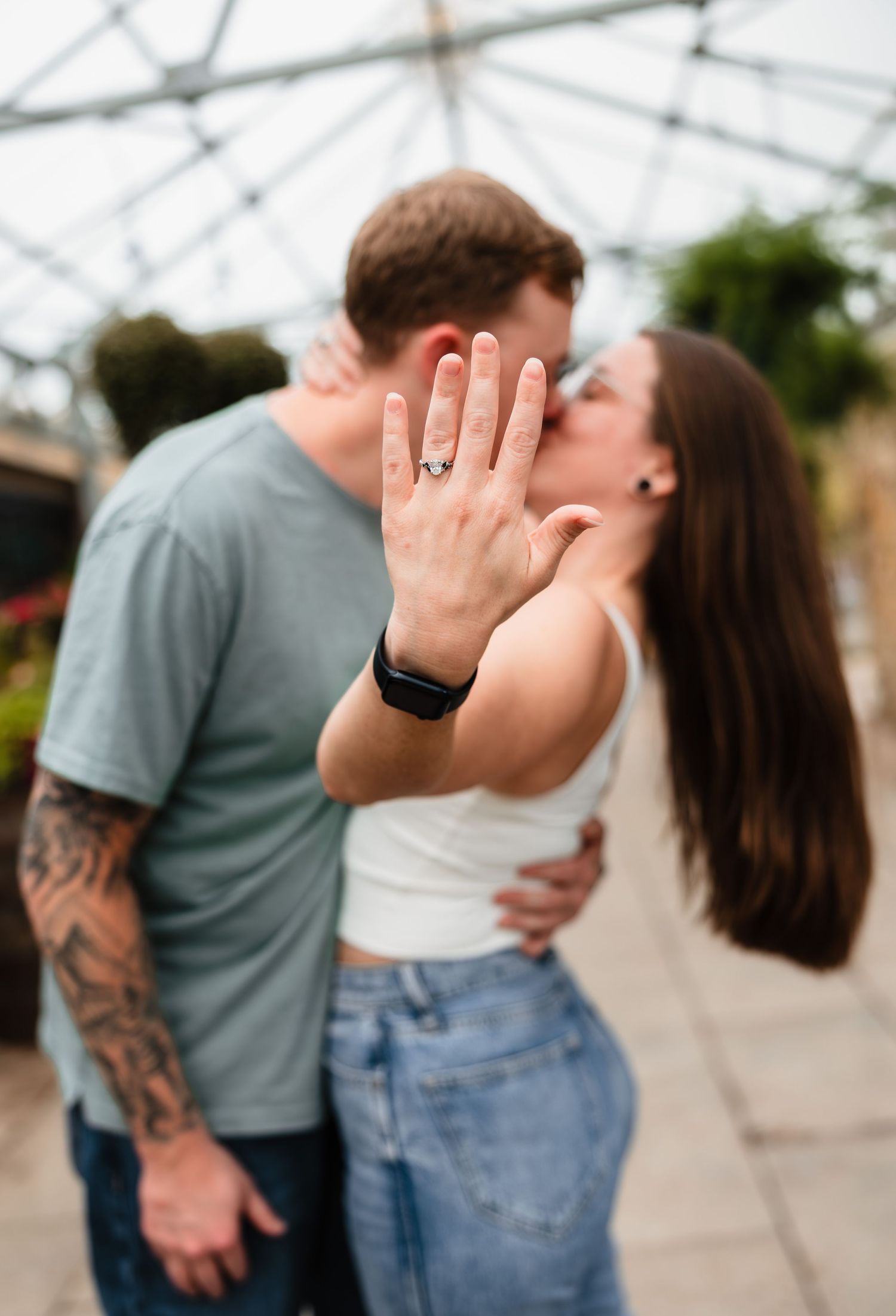 Engagement photoshoot in a flower nursery with photographer located throughout the Kansas City Metro area. Based in Blue Springs, Missouri.