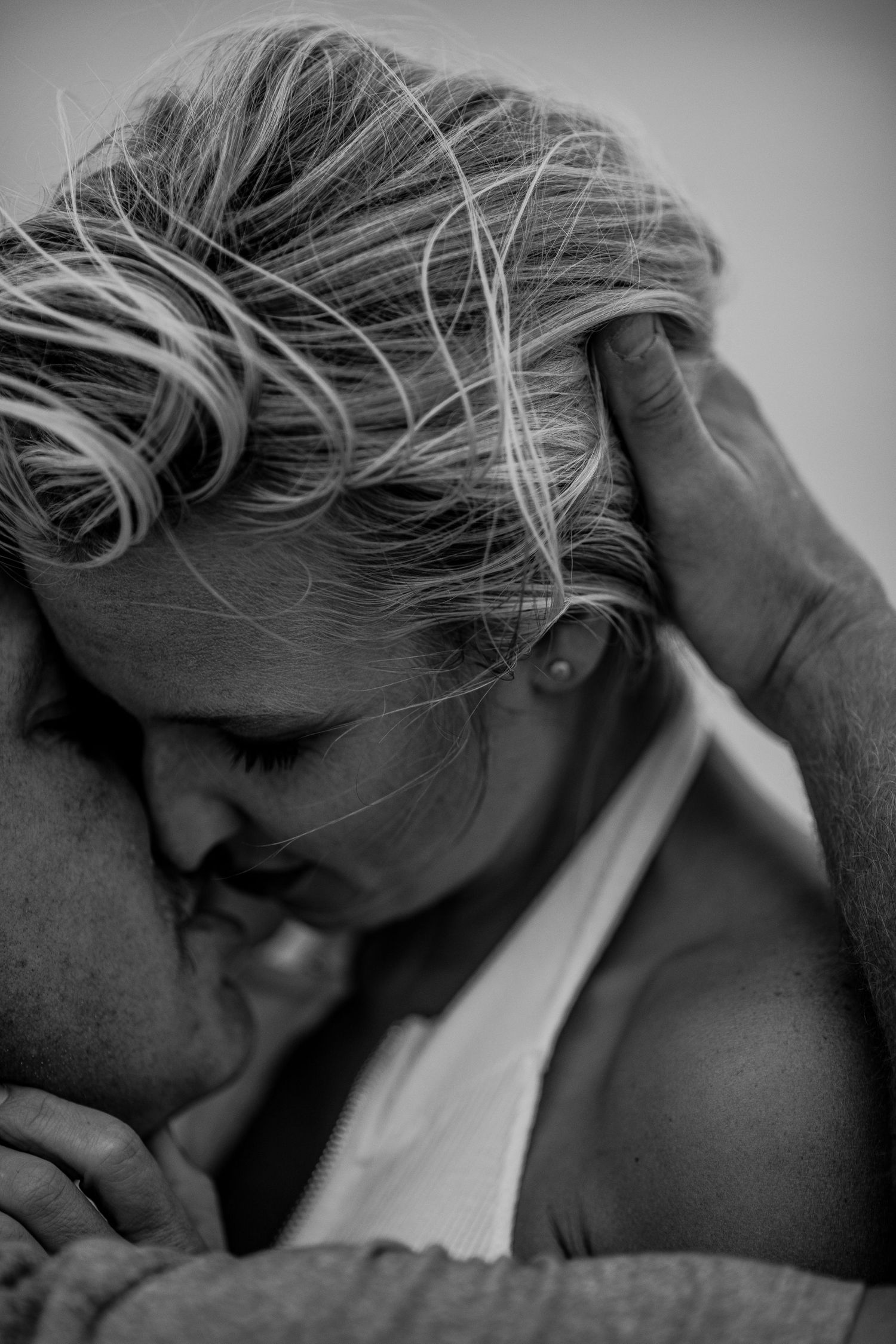 Intimate black and white photo of a couple sharing a tender kiss and embrace Cape cod couples studio Boudoir photos