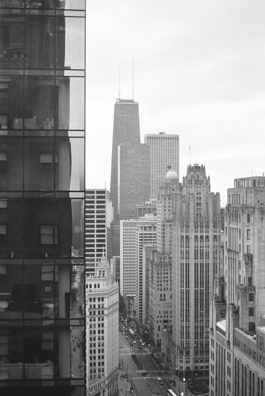 Black and white aerial view of Chicago city skyline featuring the John Hancock Center.