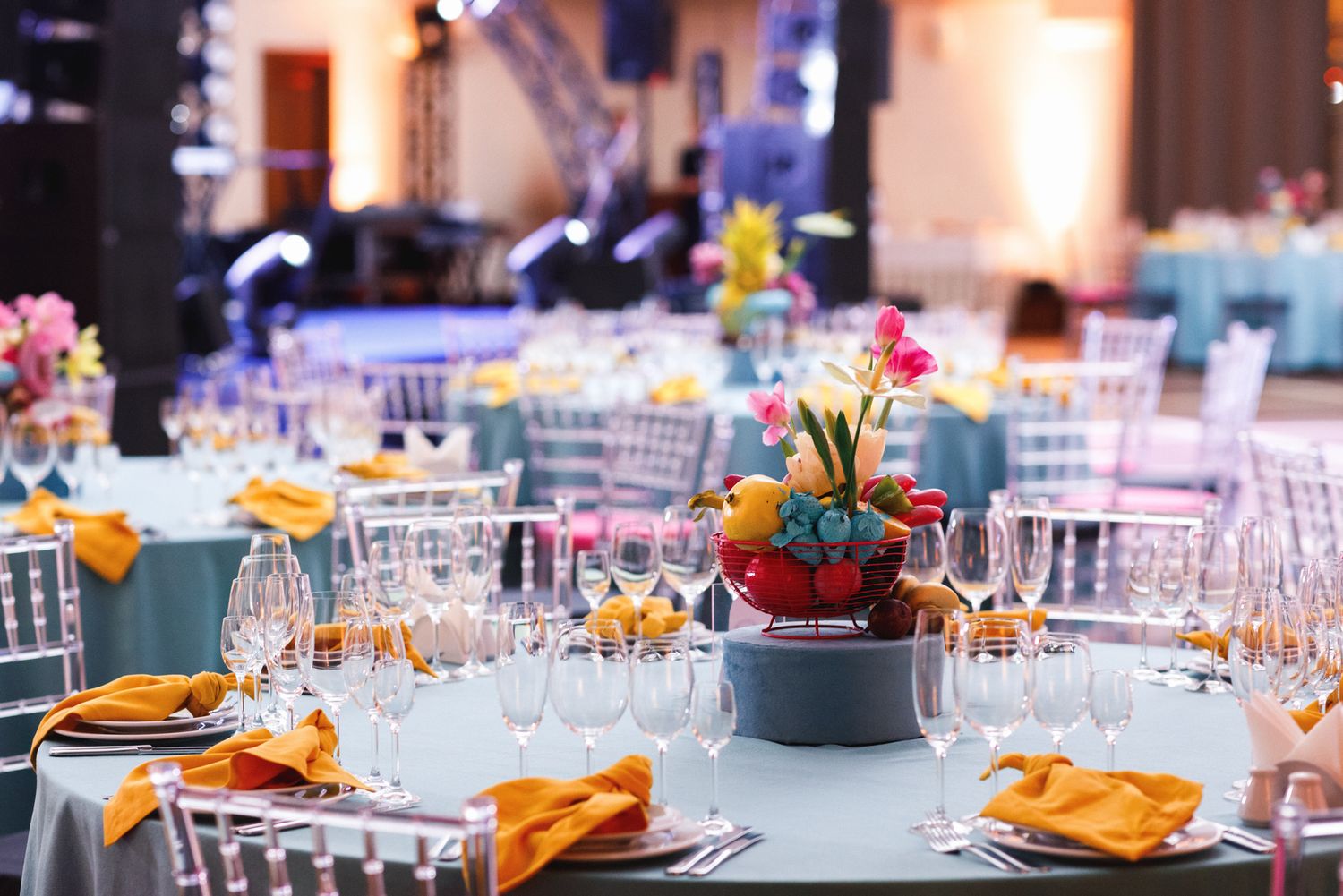 A beautifully decorated banquet room with elegant table settings and colorful centerpieces, captured by a professional event photographer.