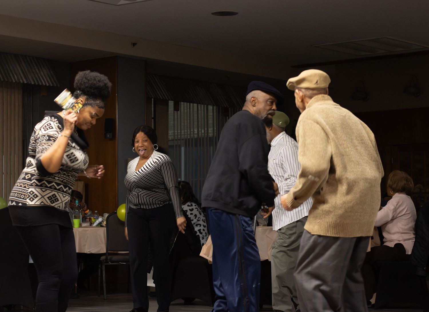 Candid moment of adults dancing together and enjoying a lively party, captured by a professional event photographer.