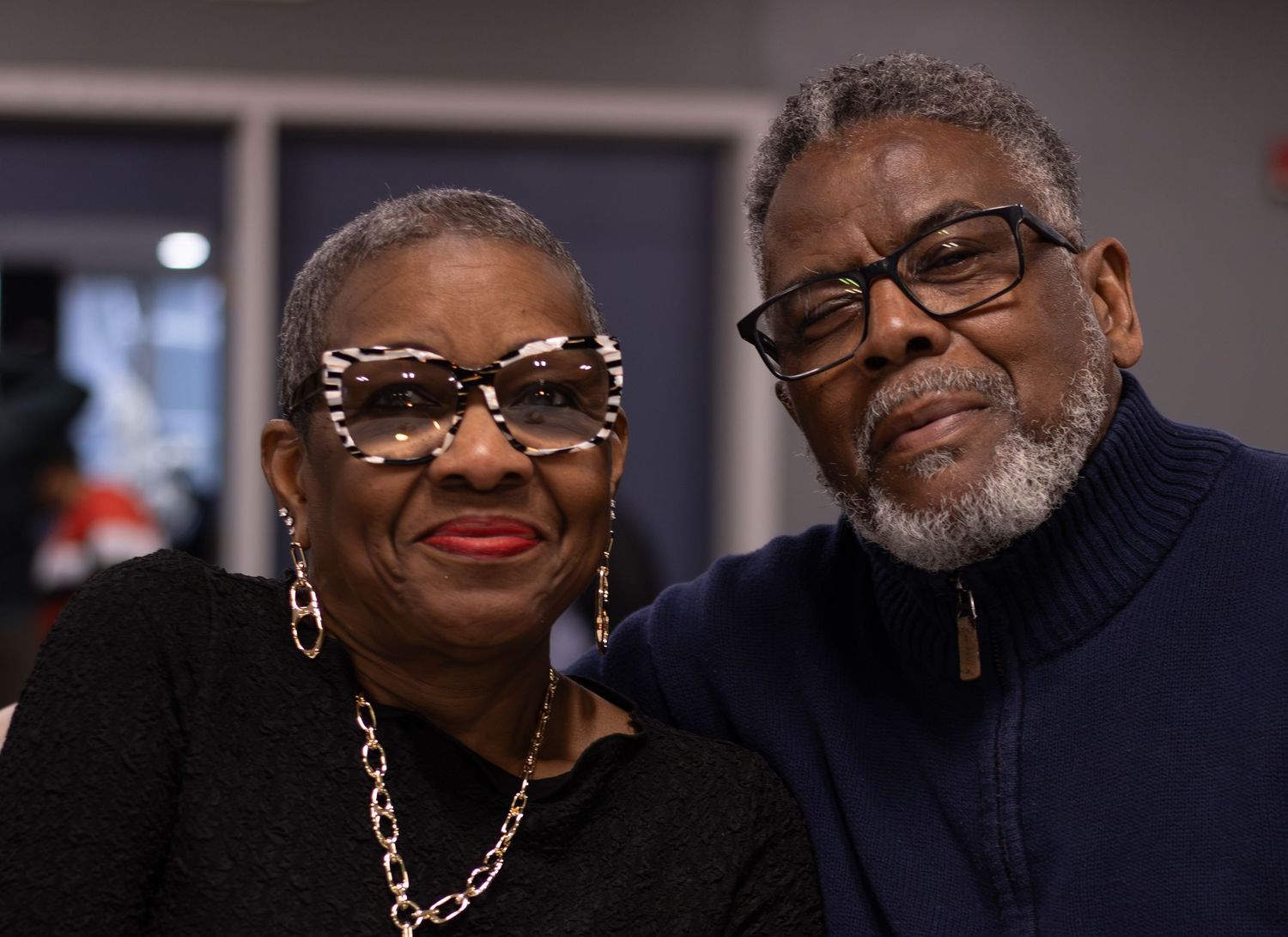 A warm and elegant portrait of a mature couple smiling together at an event, captured by a professional photographer.