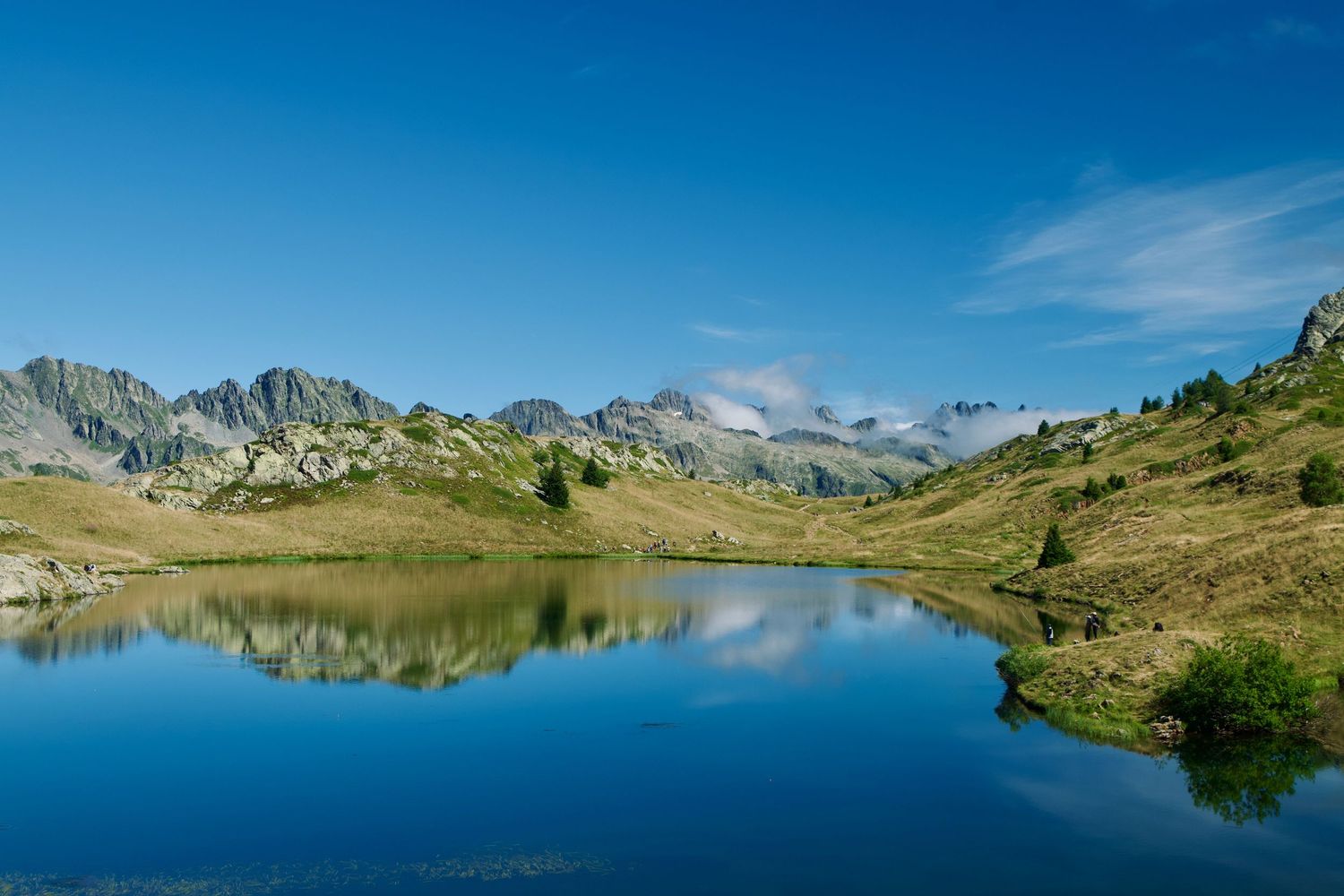 Mountains reflected in the lac noir at Alpe d'Huez taken during summer.