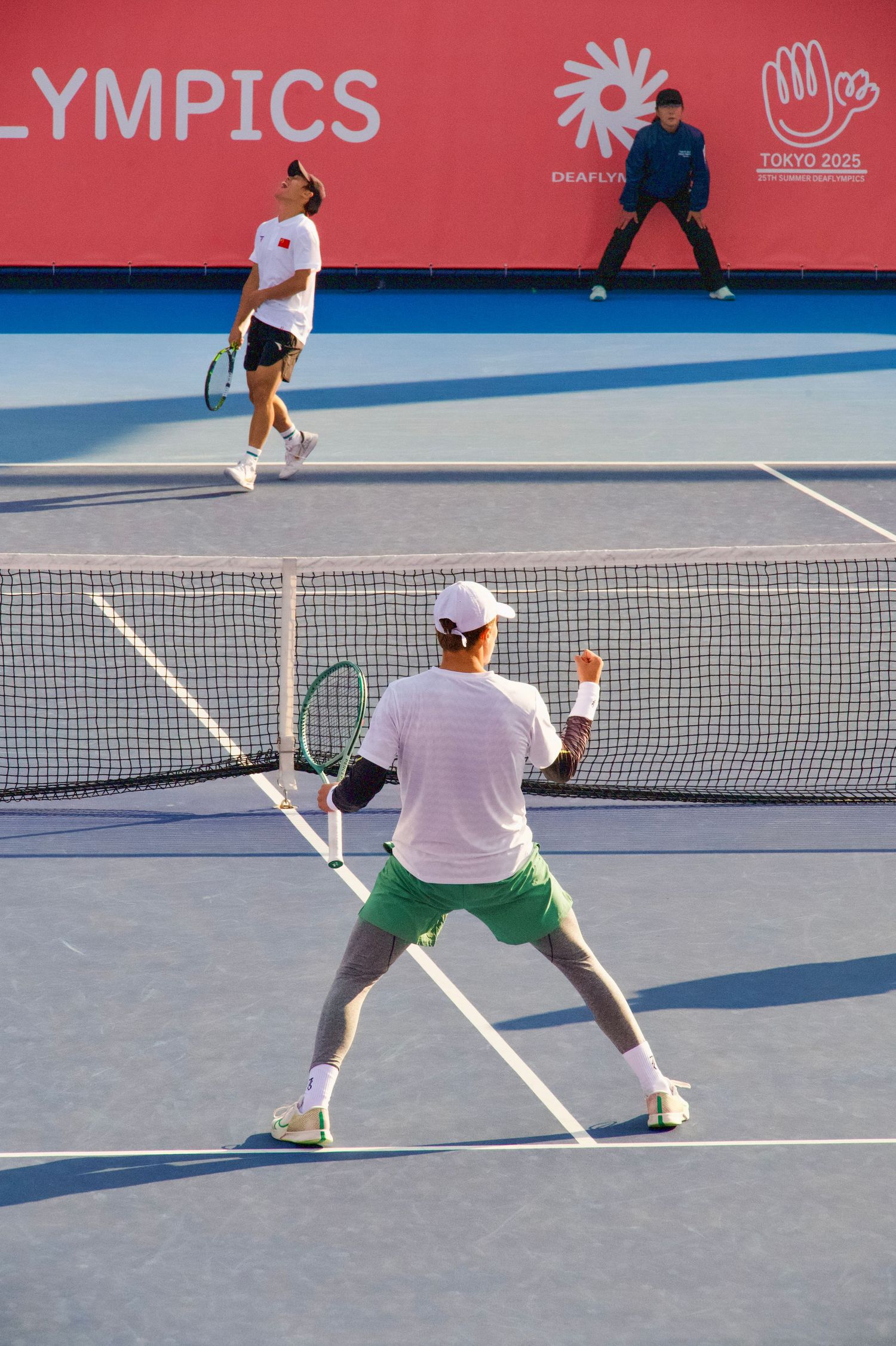 Tennis player celebrates winning a point at the 2025 Deaflympics in Tokyo
