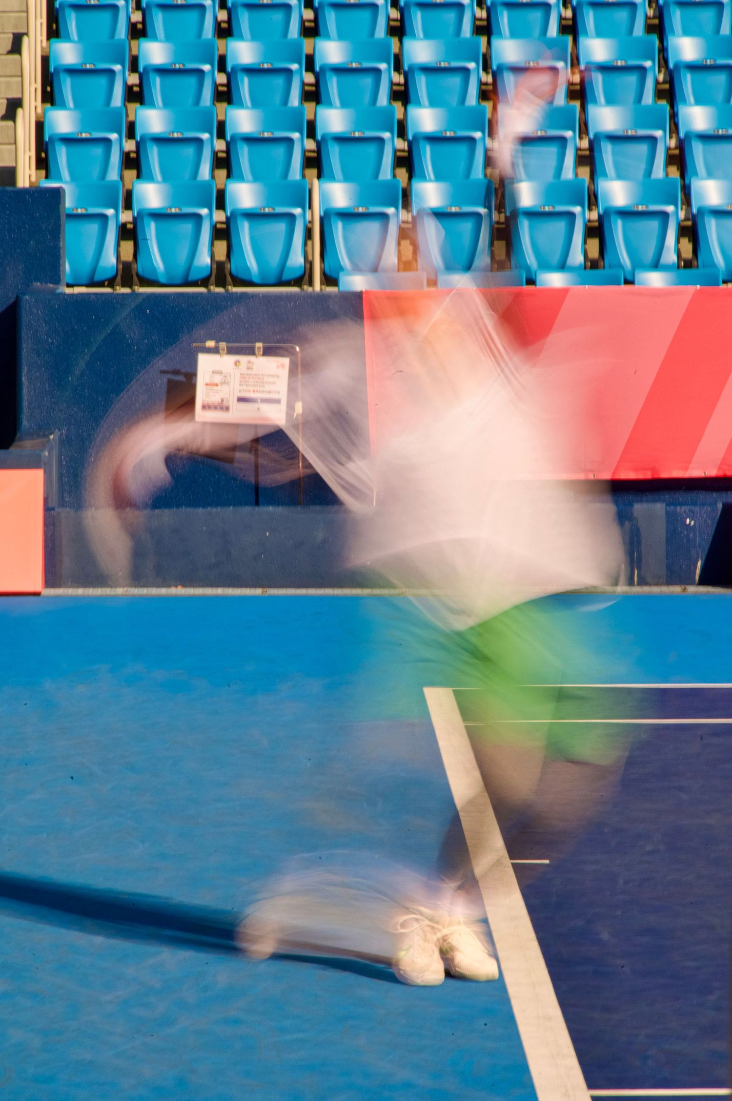 Motion blur of a tennis playing serving at the 2025 Deaflympics in Tokyo.