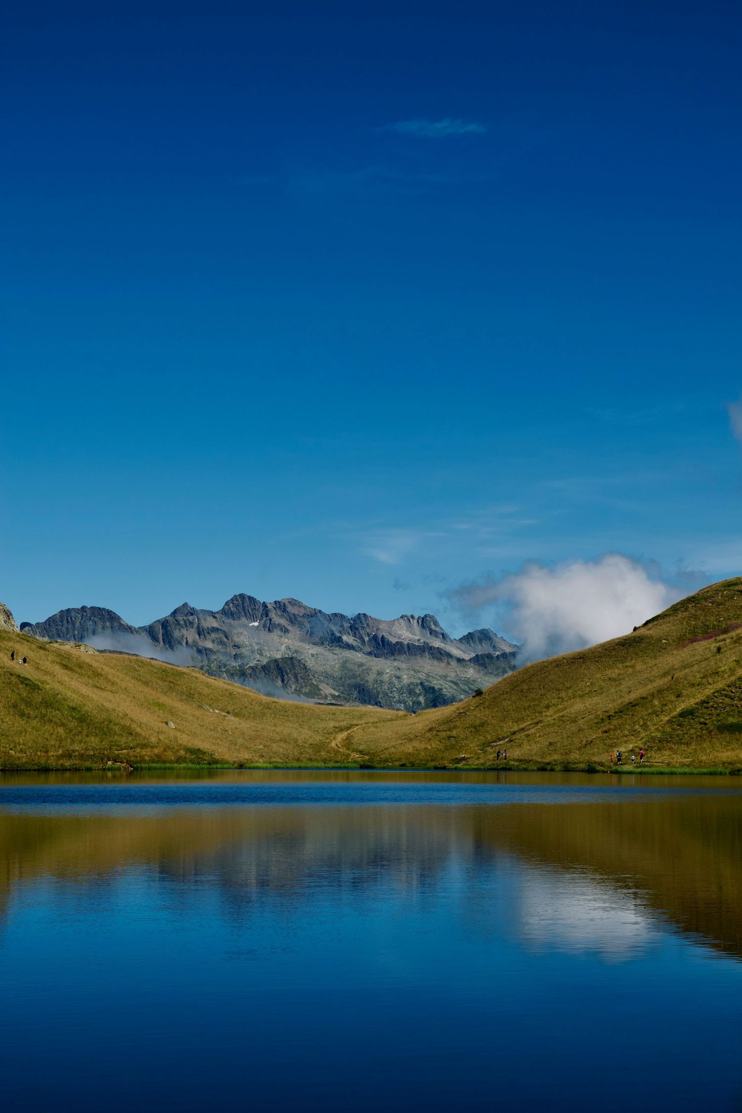 Mountains reflected in the lac faucille at Alpe d'Huez taken during summer.
