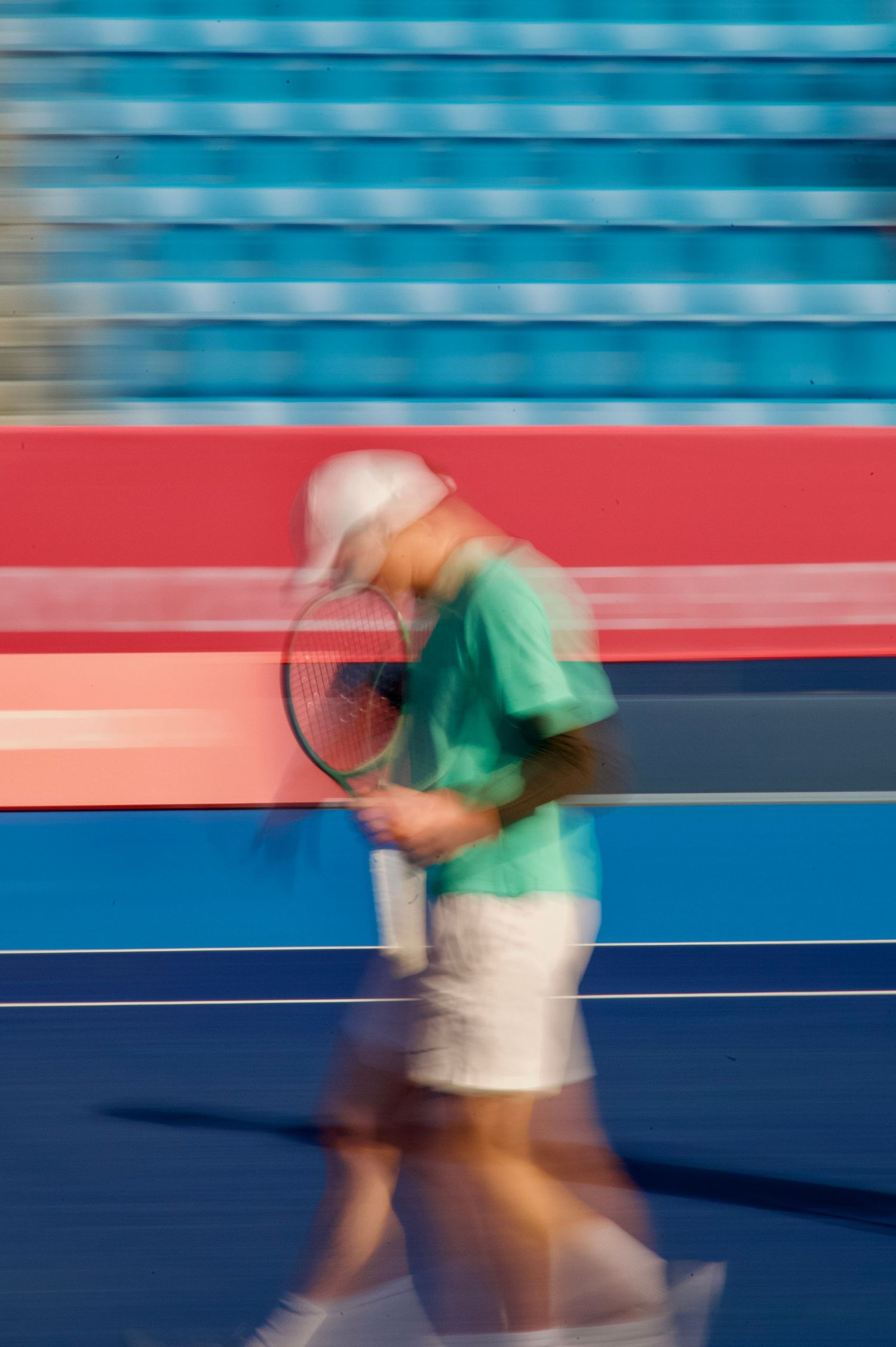 Motion blur photo of tennis player at the 2025 Deaflympics in Tokyo as they return to the service line