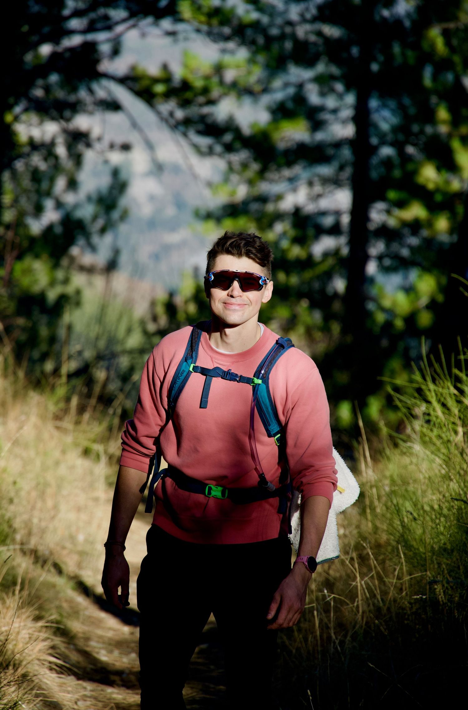 A hiker in the woods near Digne-les-bains, with the sun highlighting his face, wearing Oakley Jawbreakers.