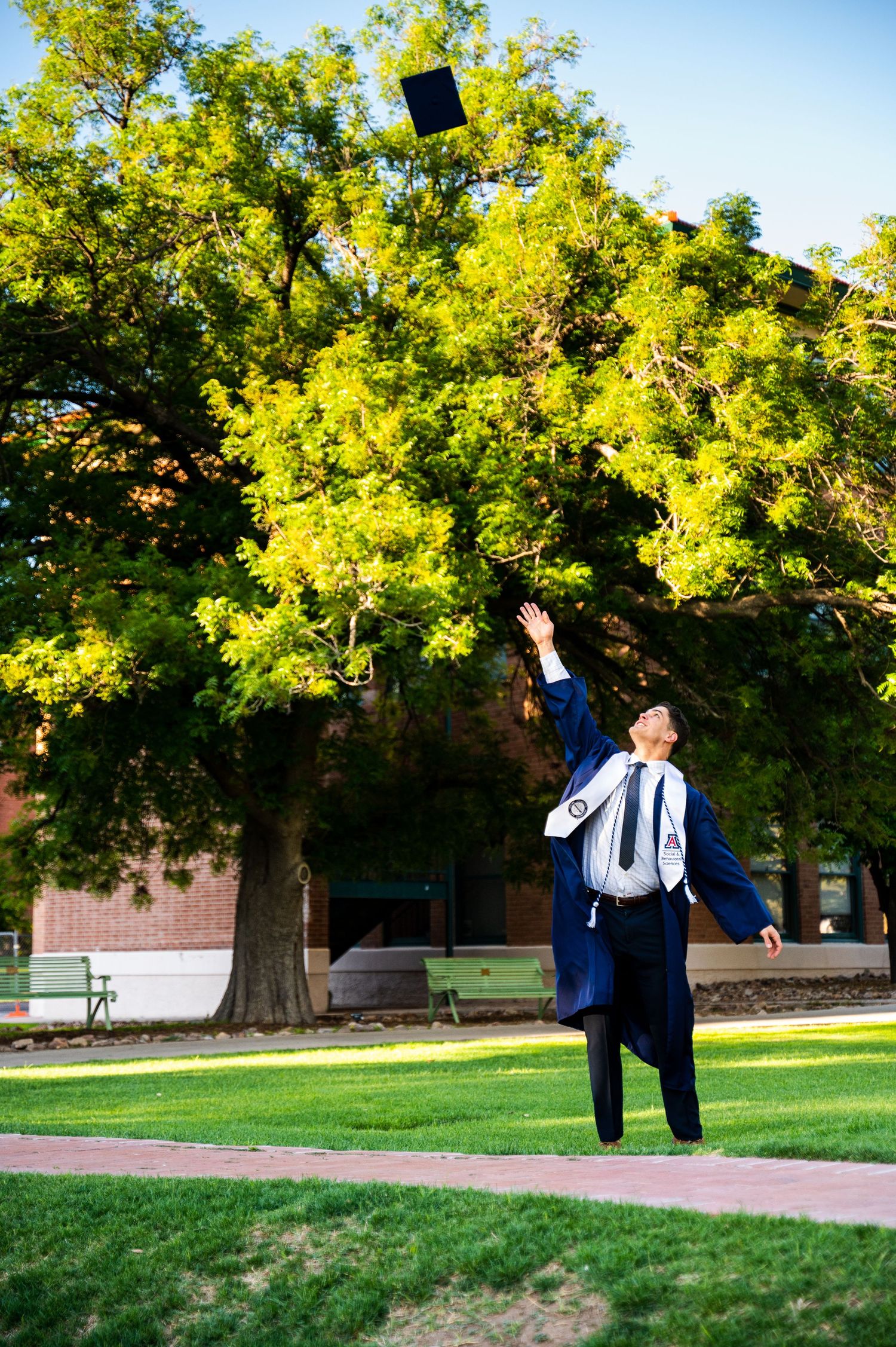 University of Arizona graduate tossing his cap in the air.