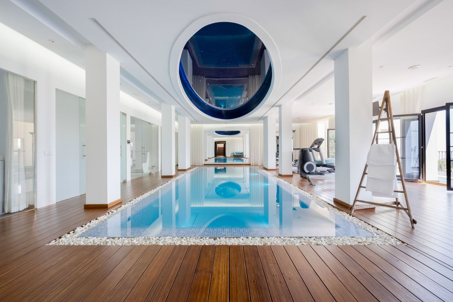 Luxury indoor swimming pool photographed in a high-end residence in Málaga, highlighting architecture, materials and soft ambient light.
