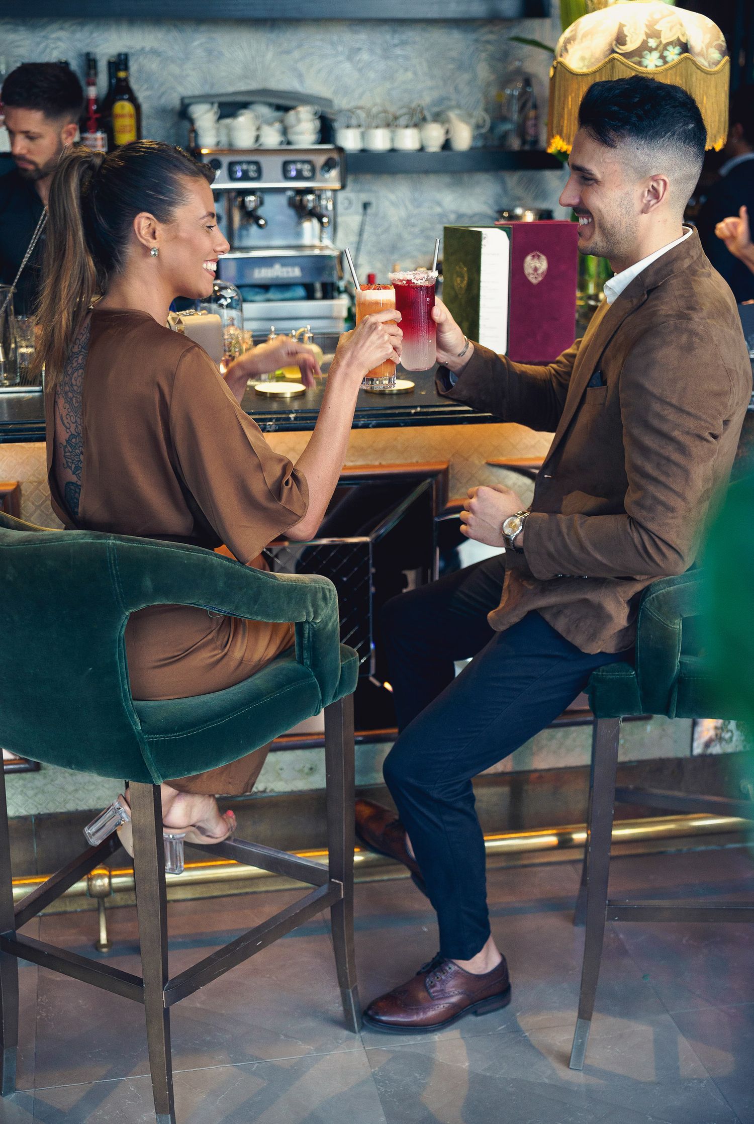 People enjoying drinks in an elegant venue in Málaga, captured with natural light and a relaxed, sophisticated atmosphere.