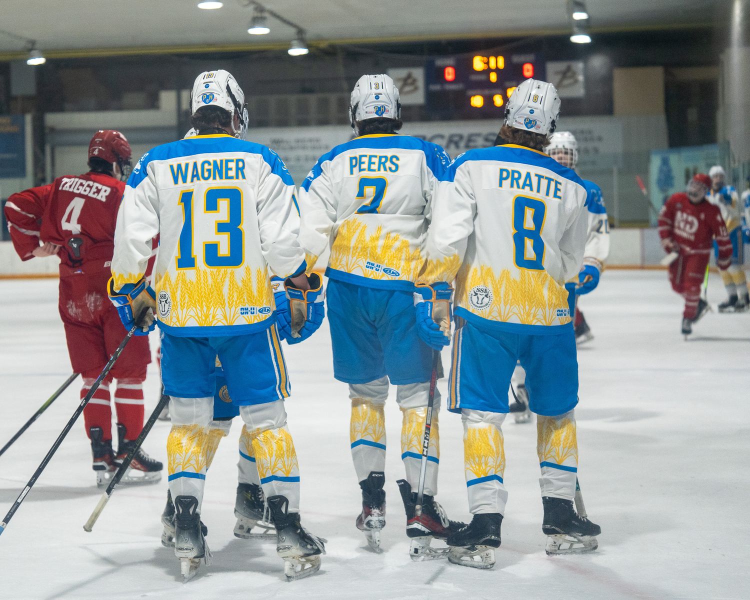 Wagner, Peers and Pratte of Prairie Hockey Academy's U17 Prep teams skating to there bench in celebration of a goal agains Notre Dame Hounds