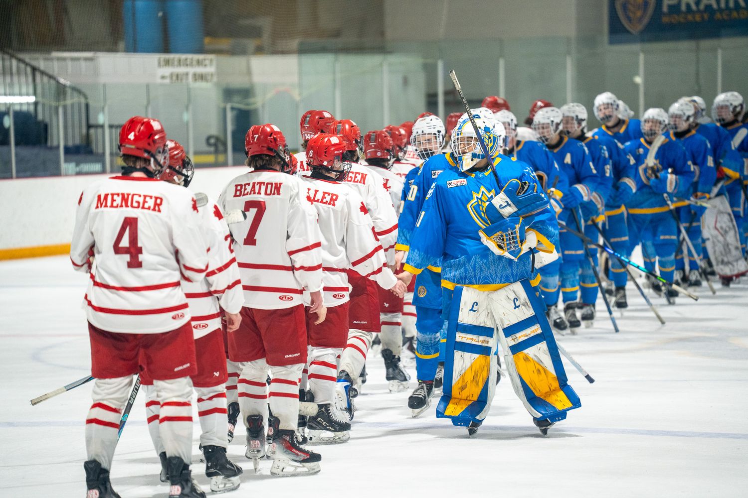 U18 Prep teams exchange handshakes following a hard-fought game between Prairie Hockey Academy and the Notre Dame Hounds.