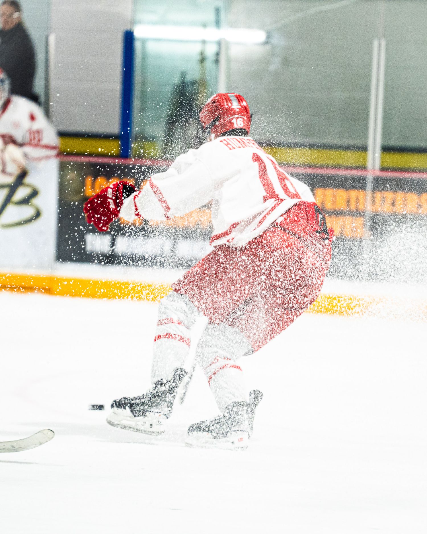 ND Hounds stop hard, ice spraying as they battle for position during U18 Prep action.