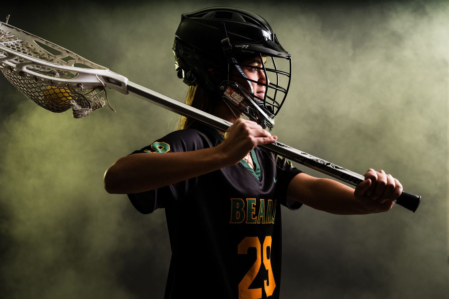 Baseball player in dark uniform swings bat against moody background with dramatic lighting and smoke effects.
