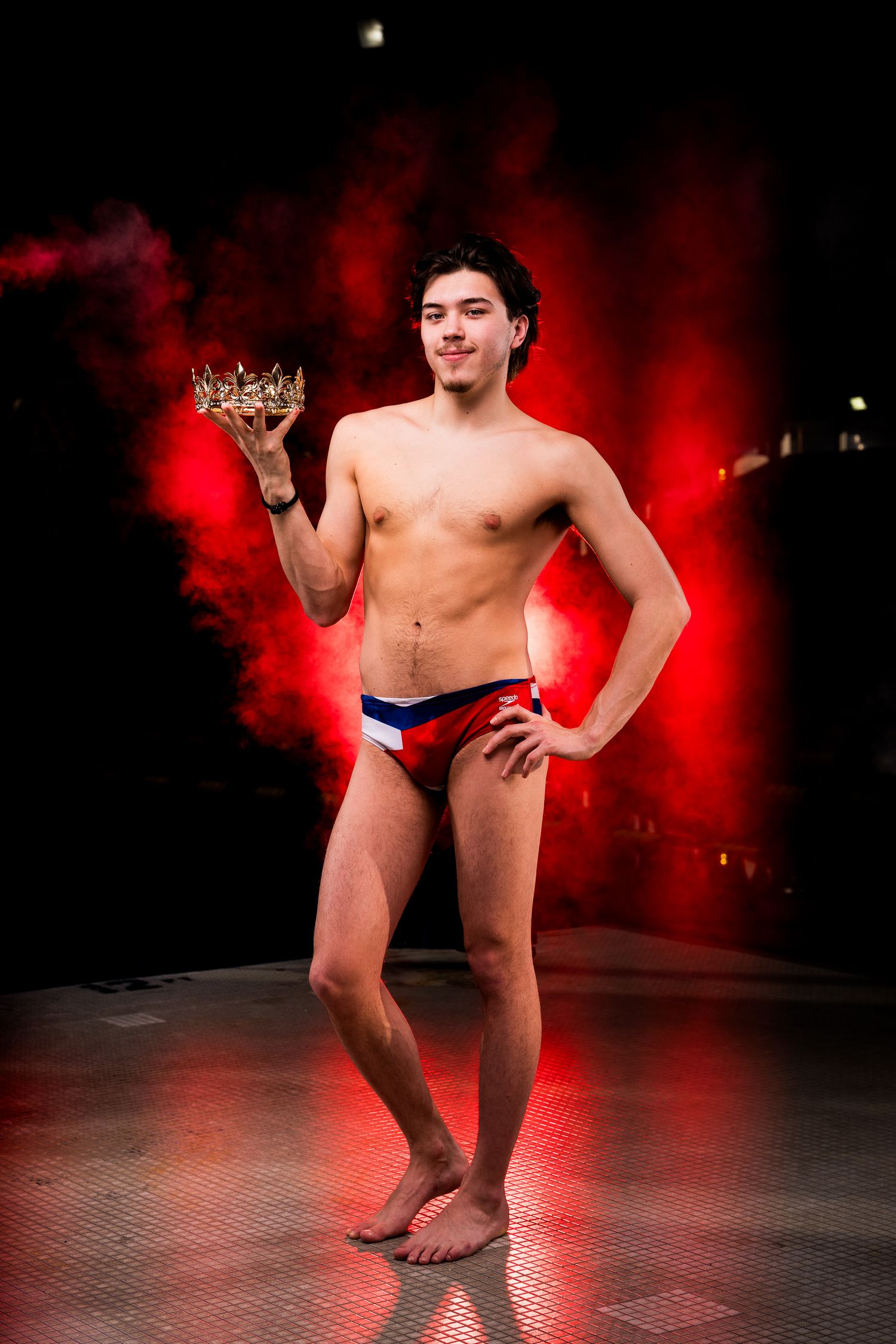 Artistic nude figure poses dramatically against dark background with red smoke effects in a photo series.