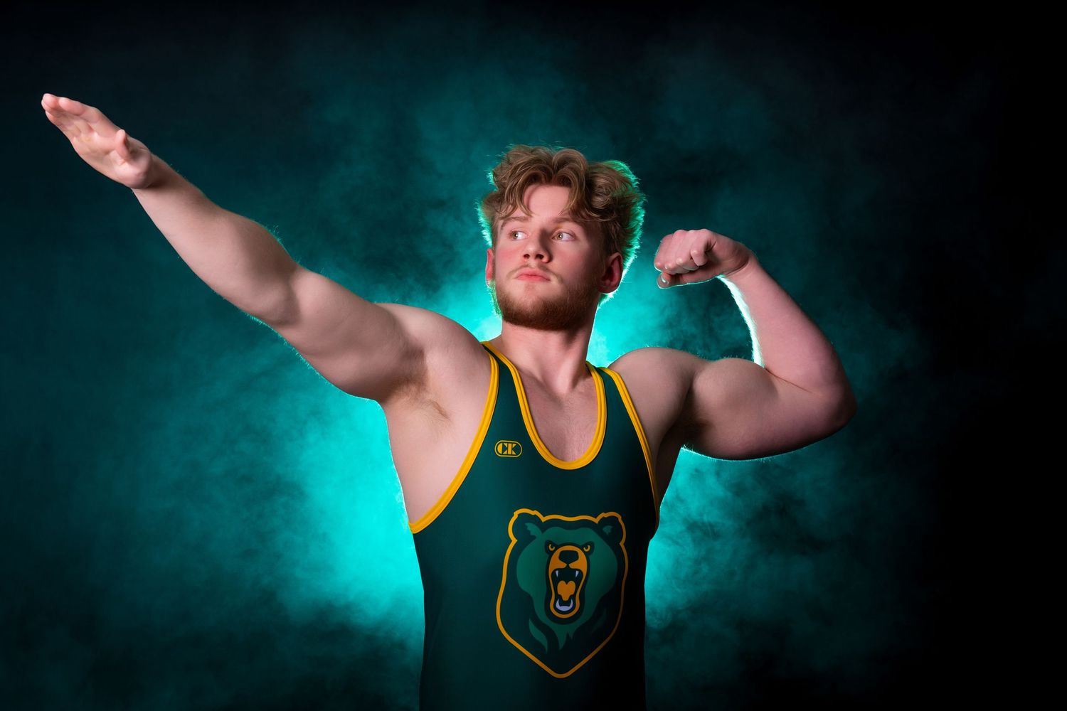 Athlete in green and gold uniform demonstrating powerful poses against teal backdrop.