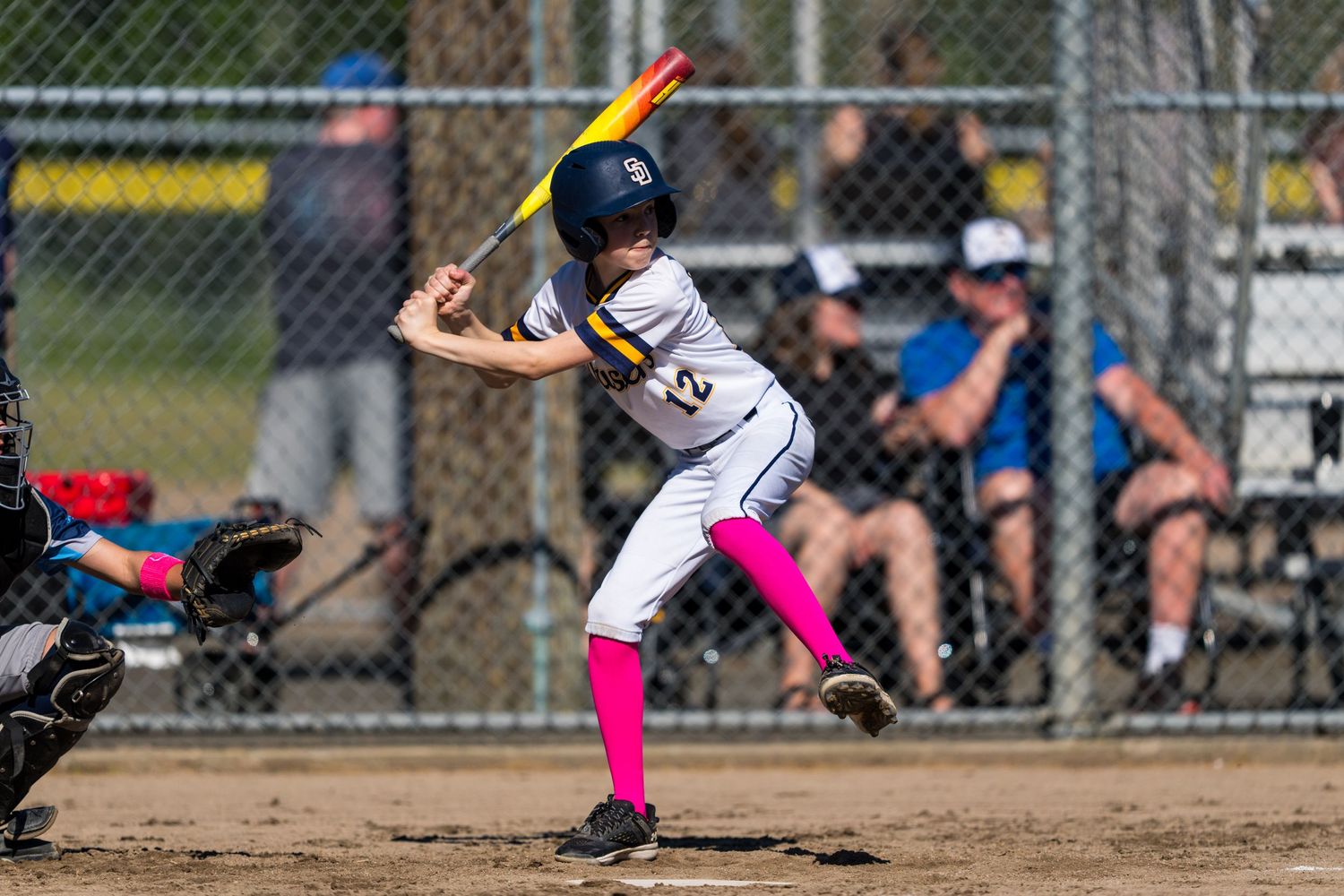 A sequence of softball players in action showing batting, fielding, and pitching moments during a game.