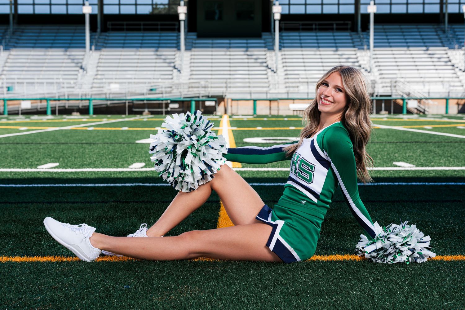 Cheerleader in green uniform poses on football field with pom poms in multiple action shots.