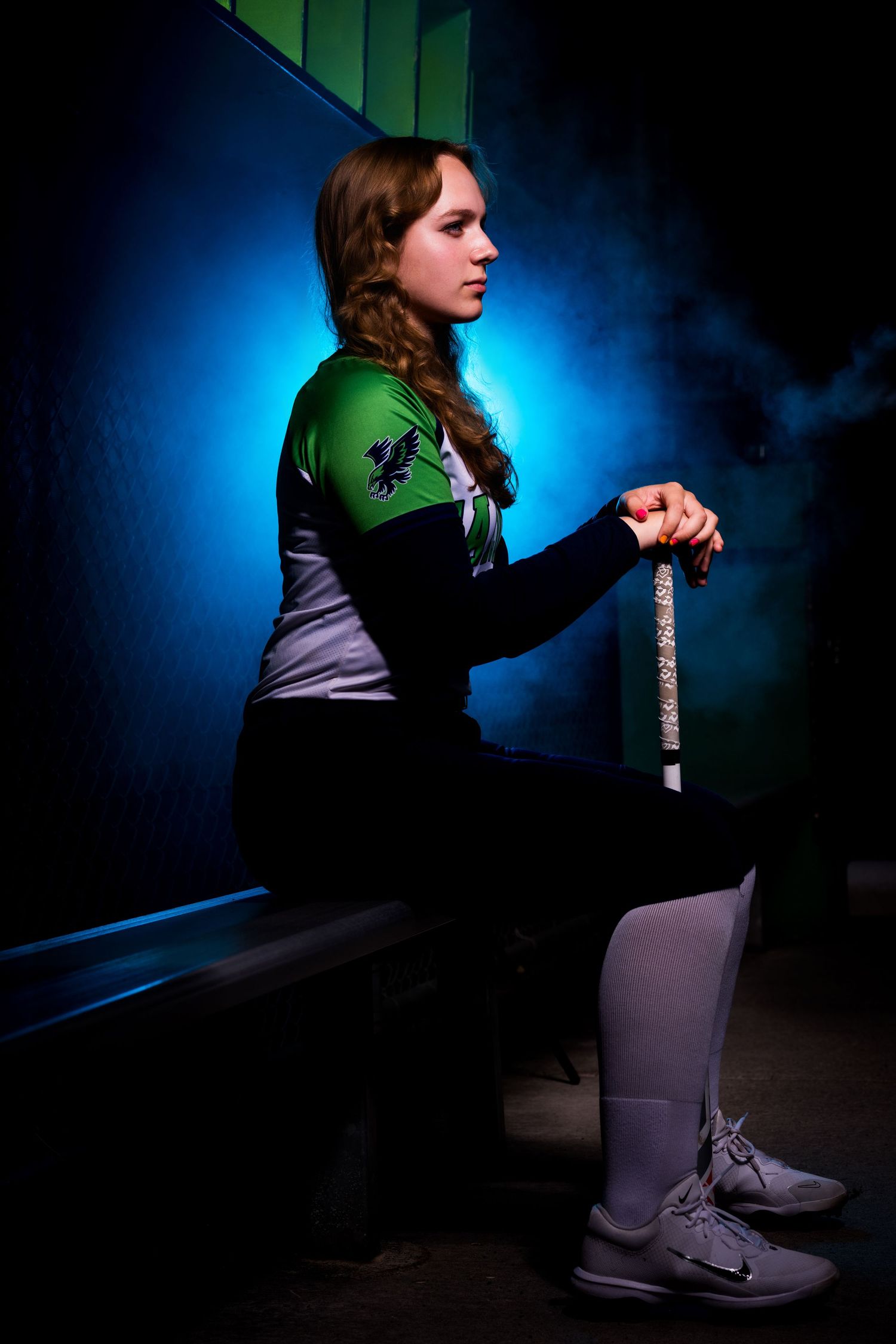 A series of dramatic silhouette photos showing a person stretching and exercising against a blue and green backlit background.