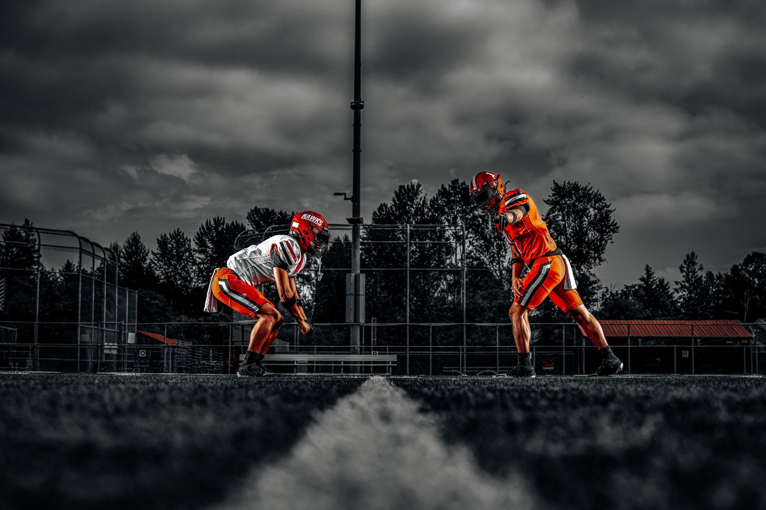 Dramatic sequence of athlete jumping over hurdles against stormy sky in selective orange coloring.