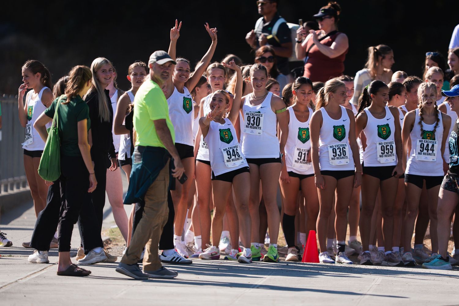 Runners lined up at the starting line of a marathon race on a sunny day.