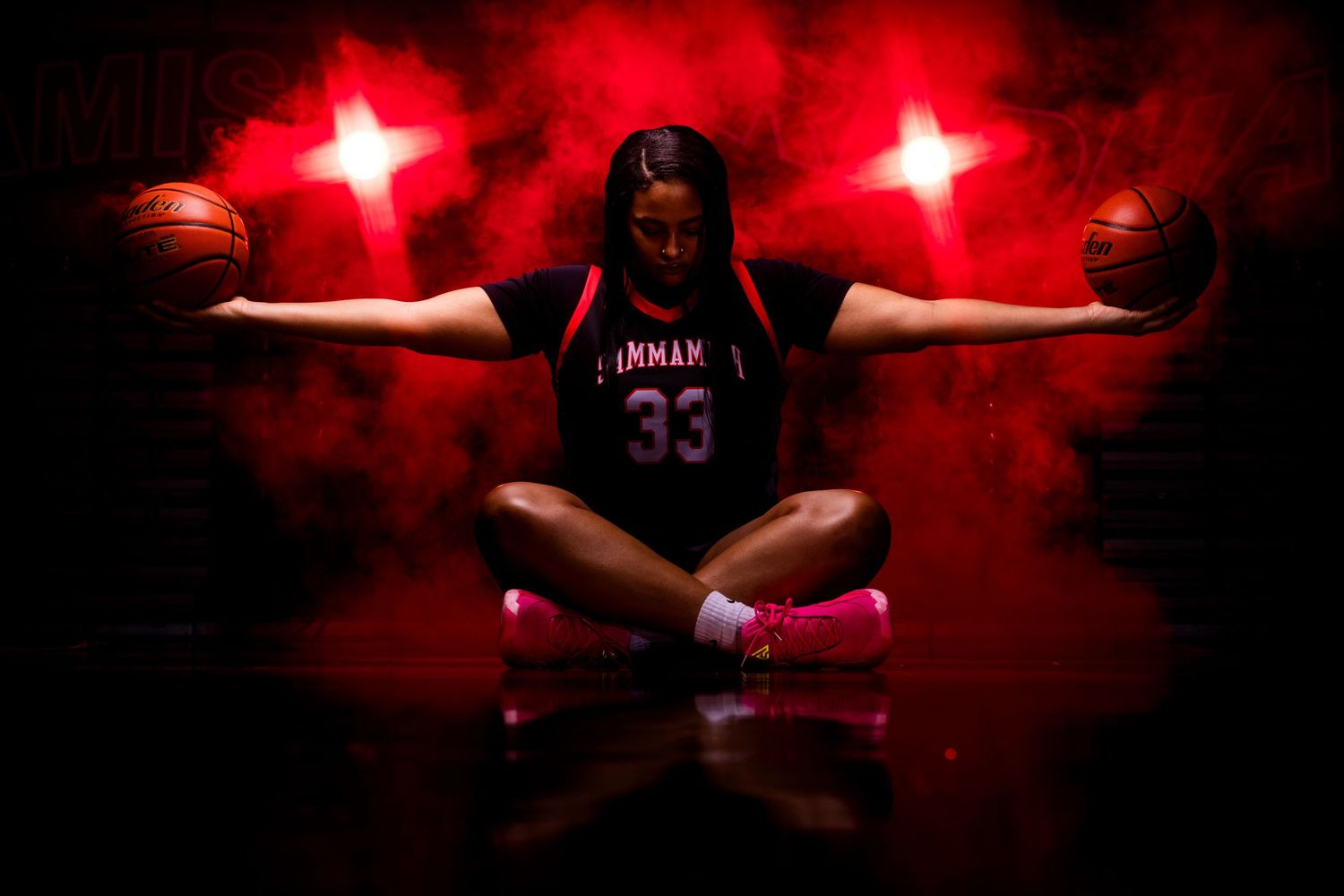 Basketball player silhouetted against dramatic red lighting during Media Day photographed by Carlos Sanchez Photography in Seattle