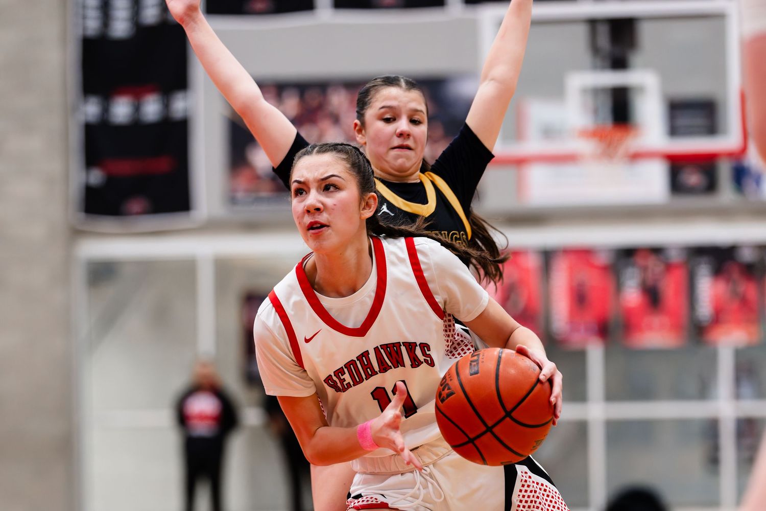 Basketball players compete for possession during an intense game on the court.