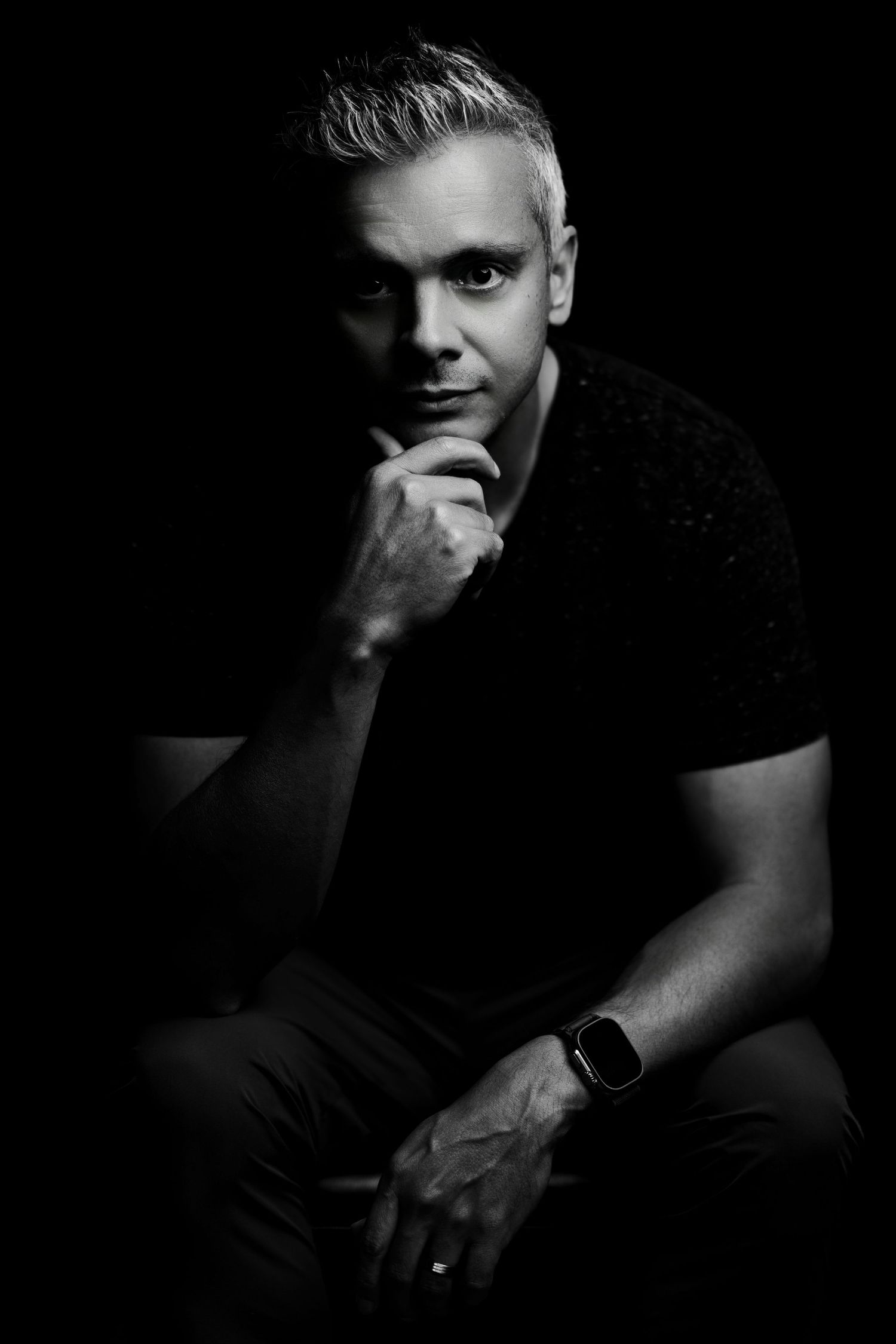 Artistic black and white portrait series with dramatic side lighting.