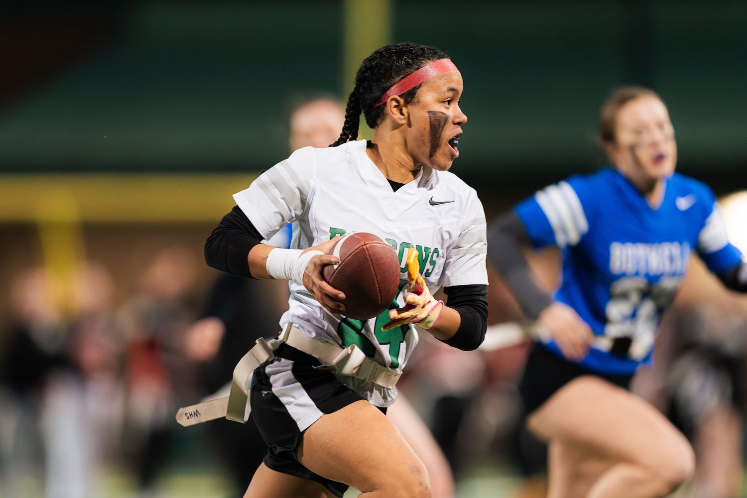 Rugby players compete intensely for possession of the ball during a professional match on the field.