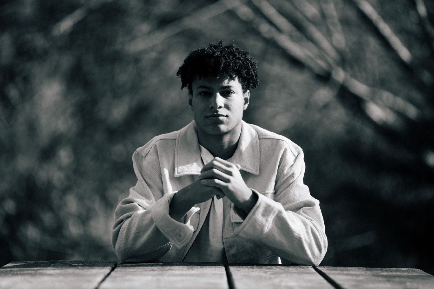 Black and white portrait series showing dramatic expressions against dark background.