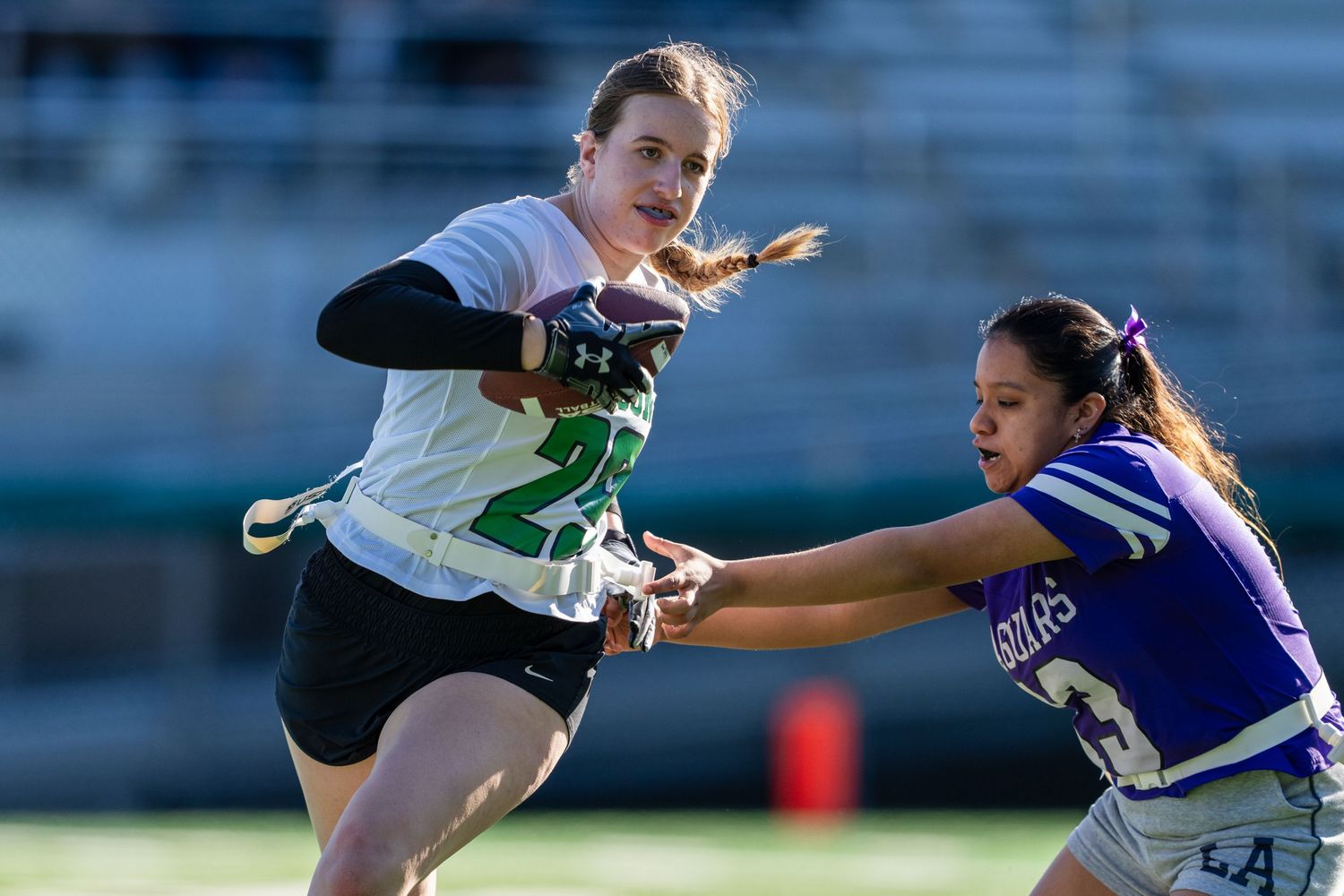 Soccer players compete for possession of the ball during an intense match on the field.