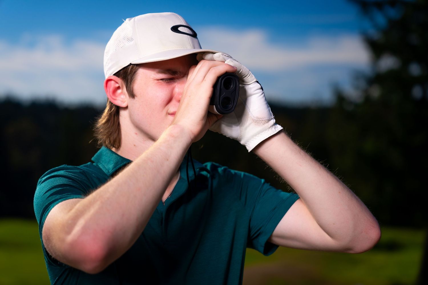 A golfer demonstrates proper golf swing technique with follow-through motion on a sunny course.