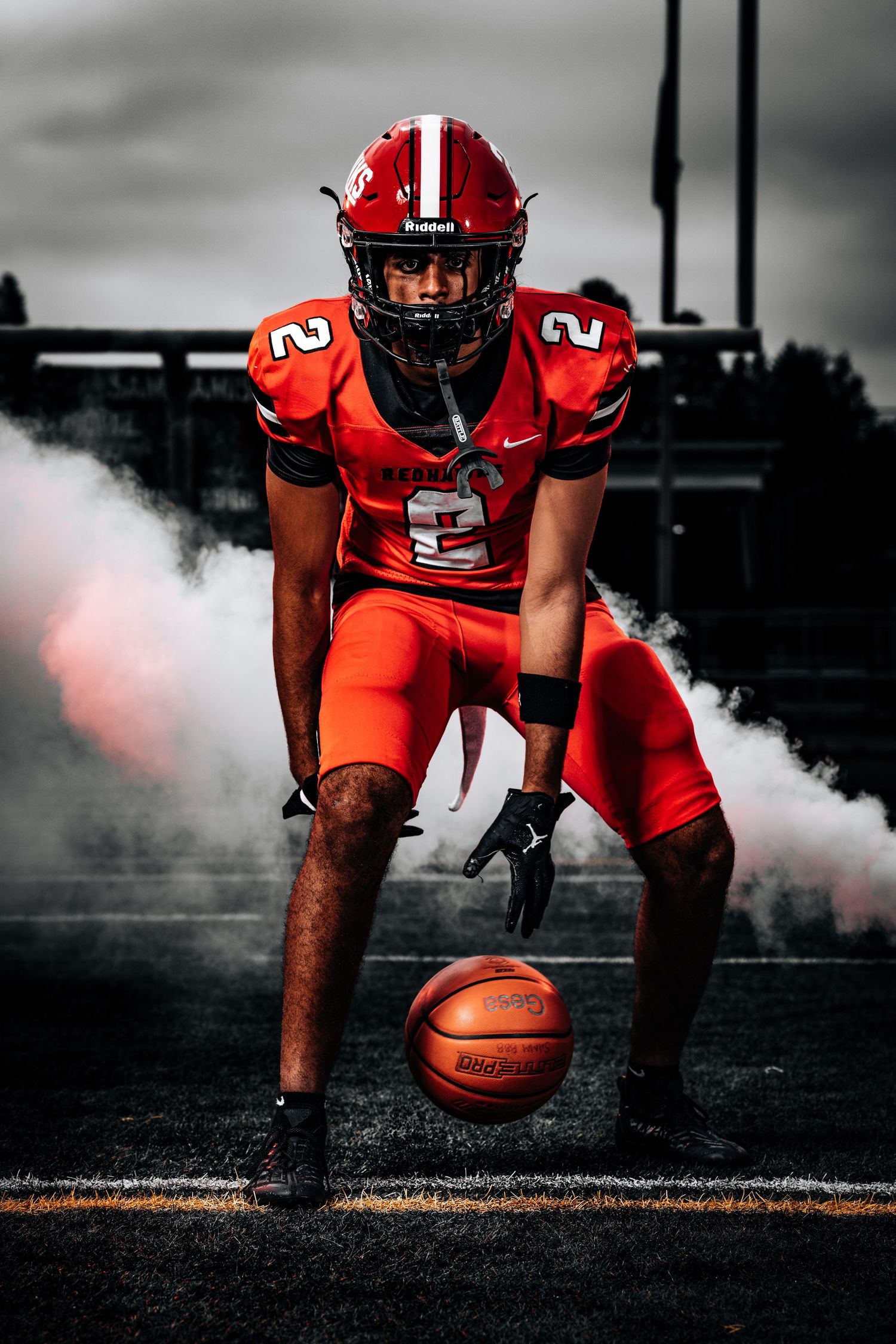 Dramatic sports photo sequence showing basketball player in red uniform crouching with ball against dark background.
